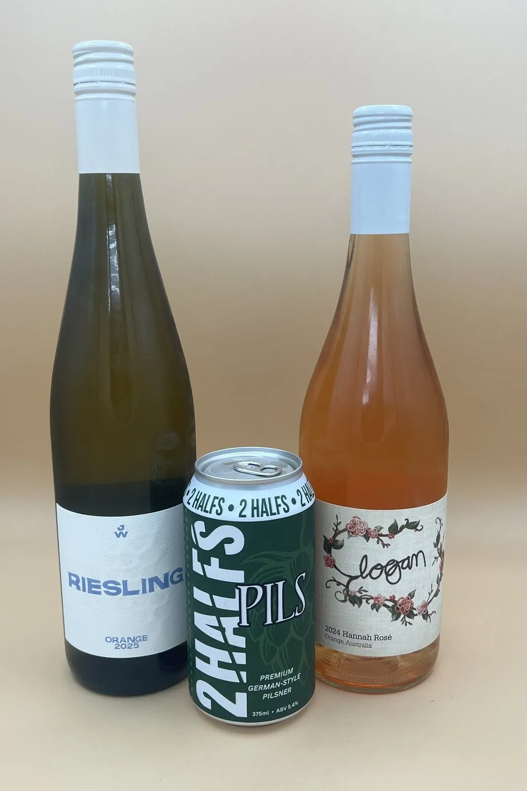 A bottle of rosé and a bottle of Riesling on a bench